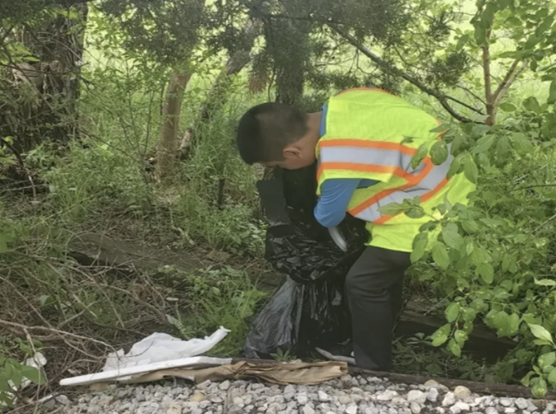 student helping with trash
