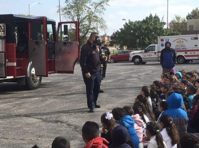 fire fighter with the kids of chs170